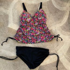 Floral swimsuit top with black bottoms. Tie string